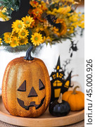 A vase of flowers, pumpkins and a scary castle with a witch on the background of a Scandi-style white kitchen interior. The concept of home and comfort. Autumn decor for Halloween. Стоковое фото, фотограф Photojuli / Фотобанк Лори