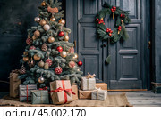 Gift boxes and a fir tree on the table in the home interior of the living room. A cozy concept for Christmas and winter holidays in 2025. Preparing gifts for loved ones. Стоковое AI-изображение, AI-художник Photojuli / Фотобанк Лори