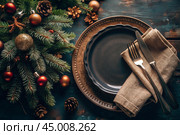 Table setting. Vintage. Stylish plates, napkin, Christmas tree branches and Christmas decorations on a wooden background. The concept of a Merry Christmas and New Year 2025. Стоковое AI-изображение, AI-художник Photojuli / Фотобанк Лори