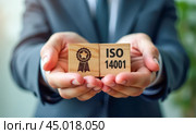 Professional in Suit Presenting ISO 14001 Standard Block, Global Environmental Management System Certification, Business Commitment to Sustainability, Eco Corporate Strategy Implementation. Стоковое AI-изображение, AI-художник Павел Муравьев / Фотобанк Лори