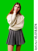 Young Woman Looking Bored and Disinterested Against Green Background. Стоковое фото, фотограф Сергей Толмачёв / Фотобанк Лори