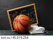 Basketball Tactics Planning With Ball and Blackboard on Wooden Floor. Стоковое фото, фотограф Сергей Толмачёв / Фотобанк Лори