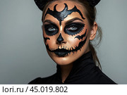 Scary Halloween makeup on a woman's face in the form of a skull, a corpse. Halloween Party. AI generated. Стоковое AI-изображение, AI-художник Ольга Симонова / Фотобанк Лори