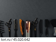 An Assortment of Professional Hairdressing Tools Laid Out on a Dark Surface. Стоковое фото, фотограф Сергей Толмачёв / Фотобанк Лори