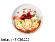 Syrniki or cheese pancakes with cream sauce and strawberry jam in white plate on white background. Стоковое фото, фотограф Татьяна Терехина / Фотобанк Лори