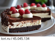 Delicious triple chocolate cake with whipped cream and raspberries topping. Стоковое AI-изображение, AI-художник Иван Рябоконь / Фотобанк Лори