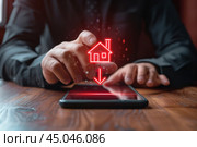 Ниспадающий график с иконкой дома и мужчиной за столом. Стоковое AI-изображение, AI-художник Александр Жуков / Фотобанк Лори