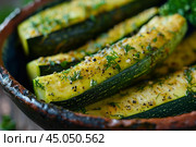 Zucchini slices being roasted with dill and black pepper. Стоковое AI-изображение, AI-художник Иван Рябоконь / Фотобанк Лори
