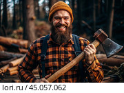 A lumberjack with an axe. The bearded woodcutter. We prepare firewood. Hiking in the forest. Forest care. A man in a plaid shirt uses an axe. A brutal male in the forest. Power and strength. Стоковое AI-изображение, AI-художник Photojuli / Фотобанк Лори