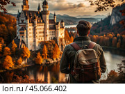 A male traveler with a backpack on the background of a huge castle in the autumn forest in the mountains. The guy travels and enjoys life and the environment. Tourism. Стоковое AI-изображение, AI-художник Photojuli / Фотобанк Лори