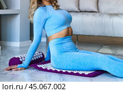 Perfect lady in blue sitting on acupressure mat doing body self care health, therapy massage. Woman sit on orthopedic acupressure mat, butt massage. Home self care medical concept. Copy ad text space. Стоковое фото, фотограф Aleksandr Golubev / Фотобанк Лори