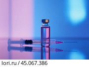 Glass ampoule with clear pink liquid and a syringe. Syringe next to the vial. Medicine bottle. Syringe of botulinum toxin, hualuronic, collagen or flu on a blue medical laboratory background. Close Up. Стоковое AI-изображение, AI-художник Марина Демидюк / Фотобанк Лори