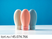 Variety of travel-sized containers displayed against a bright blue background. Стоковое фото, фотограф Сергей Толмачёв / Фотобанк Лори