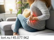 Back pain, kidney stones, body pain, inflammation of the spleen, woman suffering from backache at home. Стоковое AI-изображение, AI-художник Станислав Тарко / Фотобанк Лори