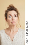 Woman with surprised exaggerated expression on neutral background. Стоковое AI-изображение, AI-художник Анастасия Золотницкая / Фотобанк Лори