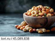 Вкусные орешки в красивой деревянной миске. Copy ad text space. Стоковое AI-изображение, AI-художник Щеголева Ольга / Фотобанк Лори