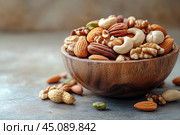 Вкусные орешки в красивой деревянной миске. Copy ad text space. Стоковое AI-изображение, AI-художник Щеголева Ольга / Фотобанк Лори