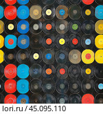 Colorful collection of vinyl records arranged artistically in a vibrant display. Стоковое AI-изображение, AI-художник Юлия Гапеенко / Фотобанк Лори