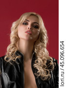 Sexy blonde in black jacket and chain view. Стоковое фото, фотограф Гурьянов Андрей / Фотобанк Лори