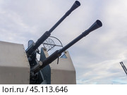Double-barreled naval automatic cannon against the sky close-up, military background. Стоковое фото, фотограф Евгений Харитонов / Фотобанк Лори