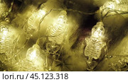 Transparent skeletons glowing yellow, close-up. Transform your space with a whimsical garland featuring glowing skeleton skulls and bones, perfect for Halloween festivities and ambiance. Horror theme. Стоковое видео, видеограф Юлия Петровская / Фотобанк Лори