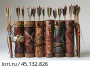 Collection of vintage handmade leather archery quivers holding arrows with feather fletching. Стоковое AI-изображение, AI-художник Иван Рябоконь / Фотобанк Лори