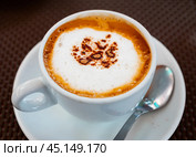 Cup of delicious hot cappuccino coffee with foam. Стоковое фото, фотограф Яков Филимонов / Фотобанк Лори