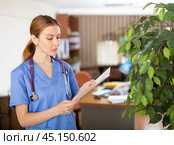 Woman doctor studying clinical diagnosis of patient in medical office. Стоковое фото, фотограф Яков Филимонов / Фотобанк Лори