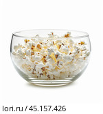 Glass bowl overflowing with buttery popcorn on white background. Стоковое AI-изображение, AI-художник Иван Рябоконь / Фотобанк Лори