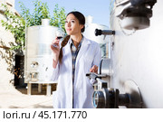 Professional woman checks the wine at factory. Стоковое фото, фотограф Татьяна Яцевич / Фотобанк Лори