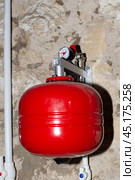 An expansion tank for the water heating system to regulate the volume of the coolant. Heating of a private residential building. Стоковое фото, фотограф Коханова Наталья / Фотобанк Лори