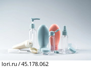 Variety of travel-sized containers displayed against a bright blue background. Стоковое фото, фотограф Сергей Толмачёв / Фотобанк Лори