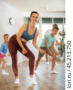 Parents with young daughter and schoolboy son are taught to move to boogie-woogie. Стоковое фото, фотограф Яков Филимонов / Фотобанк Лори