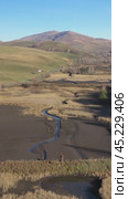 Vertical drone video of flying over a hilly rural landscape with a winding road and fish ponds. Altai Krai. Стоковое видео, видеограф Сергей Пристяжнюк (Serg Zastavkin) / Фотобанк Лори