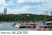Pattaya, Thailand - December 15, 2023: Pattaya City Sign, hillside landmark featuring town name in giant letters. view from ferry at bali hai pier. Редакционное фото, фотограф Павел Муравьев / Фотобанк Лори