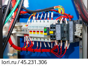 Wiring and switching equipment connecting inside an industrial control panel. Стоковое фото, фотограф Юрий Поздников / Фотобанк Лори