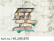Damaged old brick wall with peeling plaster close-up. Abstract background, texture. Стоковое фото, фотограф Лариса Гордеева / Фотобанк Лори