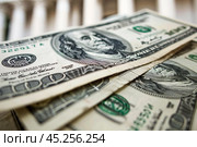 Stack of one hundred dollar bills showing concept of wealth. Стоковое AI-изображение, AI-художник Иван Рябоконь / Фотобанк Лори