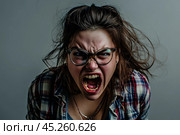 Angry Ugly Young plus size woman wearing casual clothes and glasses yelling on grey background. Стоковое AI-изображение, AI-художник Sergey Grishin / Фотобанк Лори