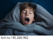 cold tones, boy in t shirt lied in bed under blanket and yawns with wide opened mouth and squint eyes. Стоковое AI-изображение, AI-художник Sergey Grishin / Фотобанк Лори