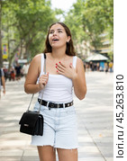 In pedestrian zone of historic European city stand suprised female tourist girl. Стоковое фото, фотограф Яков Филимонов / Фотобанк Лори