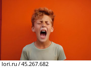 extremely whim Upset blond curly haired boy in t shirt screaming and crying or very emotional expression sings songs with wide opened mouth and closed eyes against orange color wall. Singer audition. Стоковое AI-изображение, AI-художник Sergey Grishin / Фотобанк Лори
