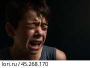 Caucasian boy cries with tears. Upset child. Violence in family over children. Concept of bullying, depressive stress or frustration. Kid close up view. Pure authentic emotion. Copy space for text. Стоковое AI-изображение, AI-художник Sergey Grishin / Фотобанк Лори