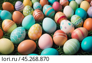 Group of colorful easter eggs laid on blanket. Multi colored easter eggs against bright wool blanket background. Concept of family traditions, Pascha, Resurrection Sunday, Christian cultural holiday. Стоковое AI-изображение, AI-художник Sergey Grishin / Фотобанк Лори