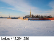 View of the Peter and Paul Fortress and Vasilievsky Island from the Trinity Bridge over the Neva River on a sunny winter morning with clouds, St. Petersburg, Russia. Стоковое фото, фотограф Ula Ulachka / Фотобанк Лори