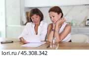 Women are sitting at table with papers and are immensely happy. Стоковое видео, видеограф Яков Филимонов / Фотобанк Лори