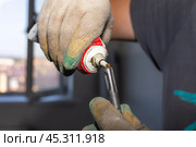 Worker lubricates the iron drill of the drill with oil technical lubricant, maintenance of tools. Стоковое фото, фотограф Коханова Наталья / Фотобанк Лори