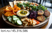 Красочное средиземноморское мезе-ассорти для кулинарного вдохновения и креативной подачи блюд. Стоковое AI-изображение, AI-художник ФотоИнтеллект / Фотобанк Лори
