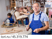 Portrait of professional seniore man carpenter standing in furniture repair shop. Стоковое фото, фотограф Яков Филимонов / Фотобанк Лори
