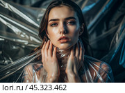 The girl is wrapped in cellophane or a bag. The girl is suffocating. Plastic pollution of the planet. Environmental hazard. Reducing the reuse of plastic. Recycling. The concept of garbage. Стоковое AI-изображение, AI-художник Photojuli / Фотобанк Лори